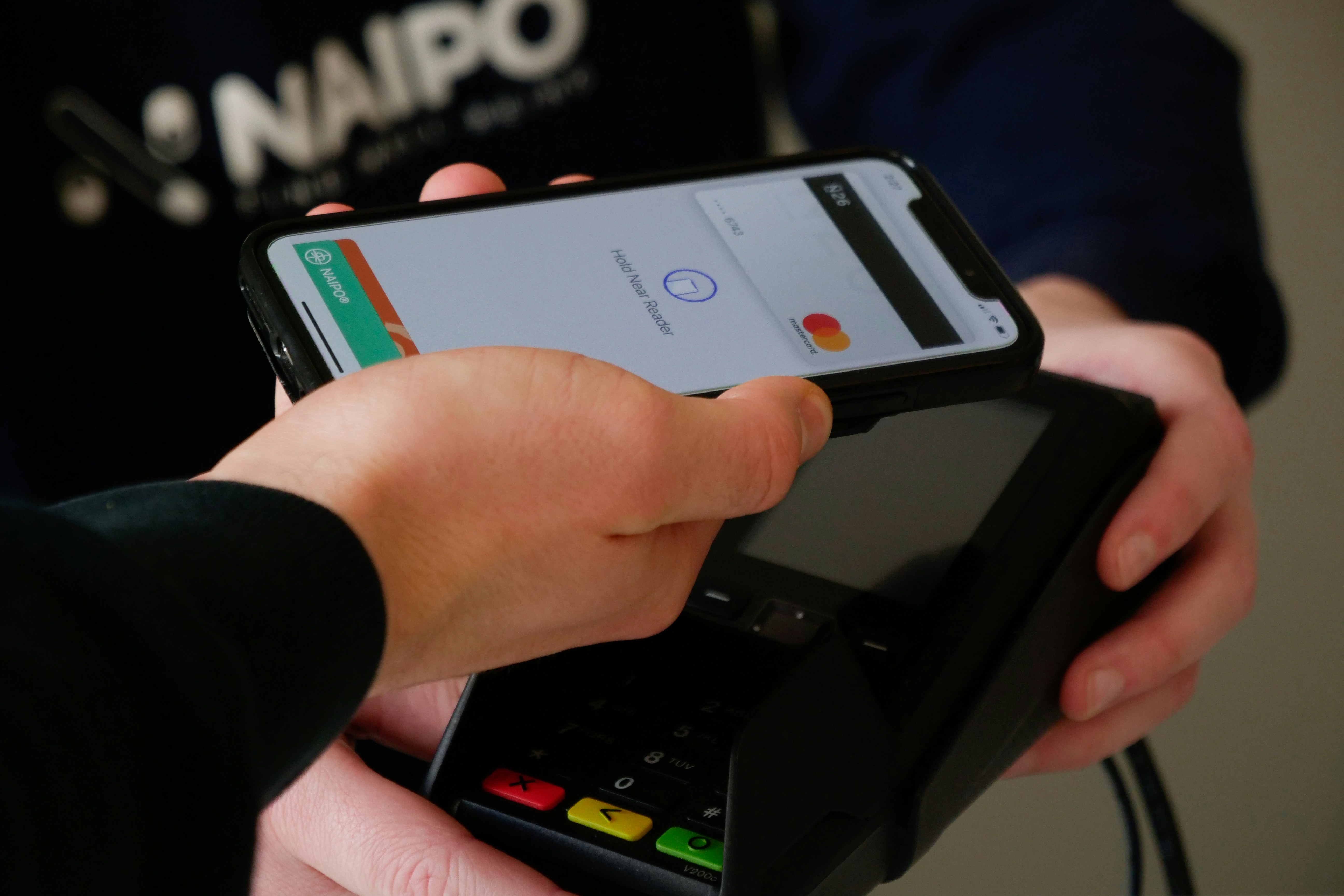 Guest paying with card and phone — fiat and crypto checkout on an embedded widget